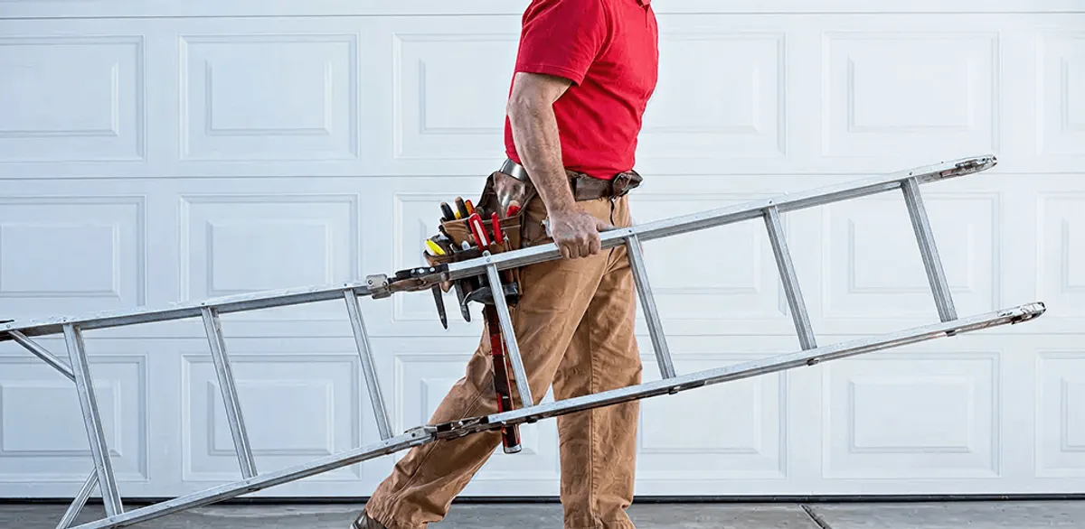 Garage door repair technician arriving with tools and ladder in Fort Wayne, IN